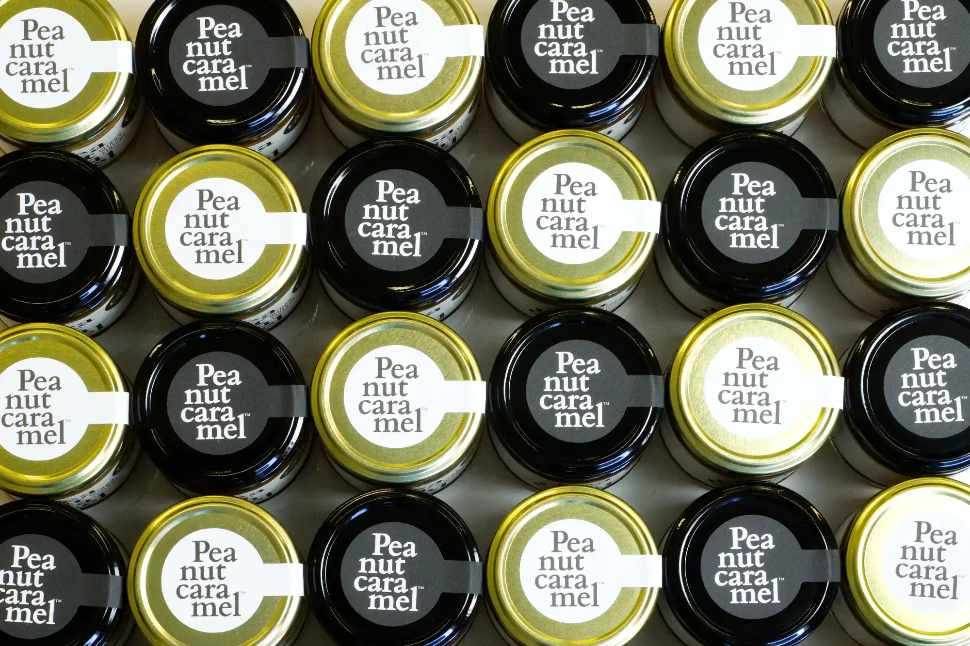 A photo of jars of Peanut Caramel taken from above, showing the lids